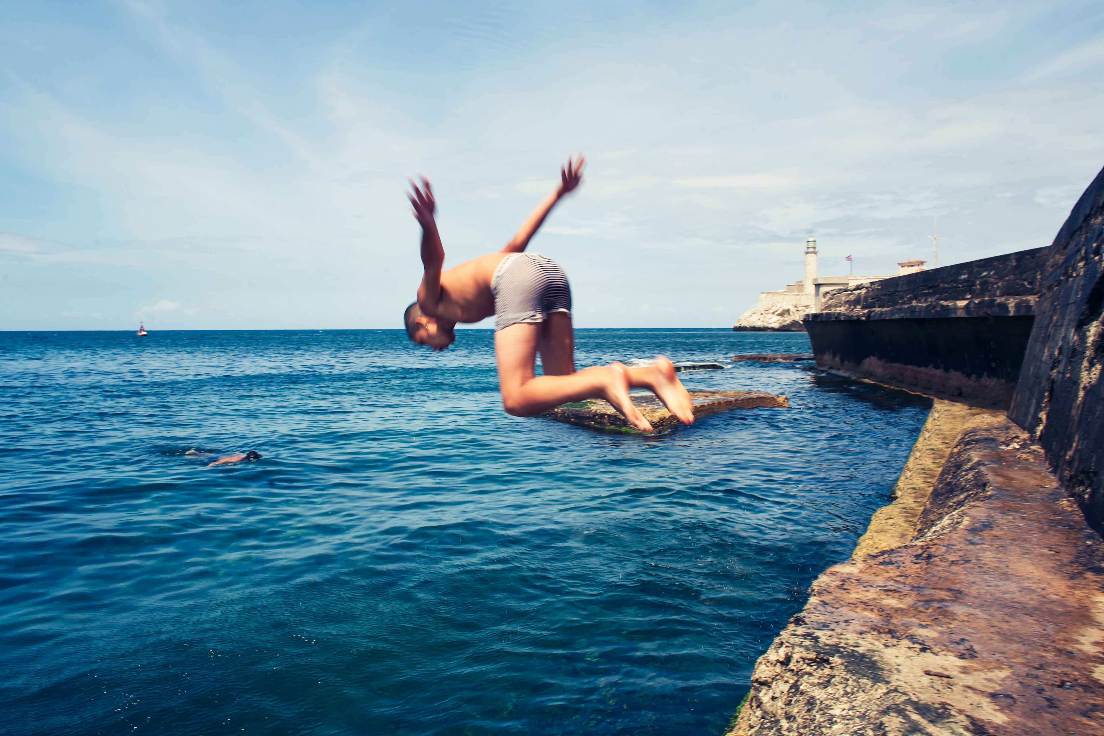 A boy dives into the sea from the Malécon, Havana, Cuba