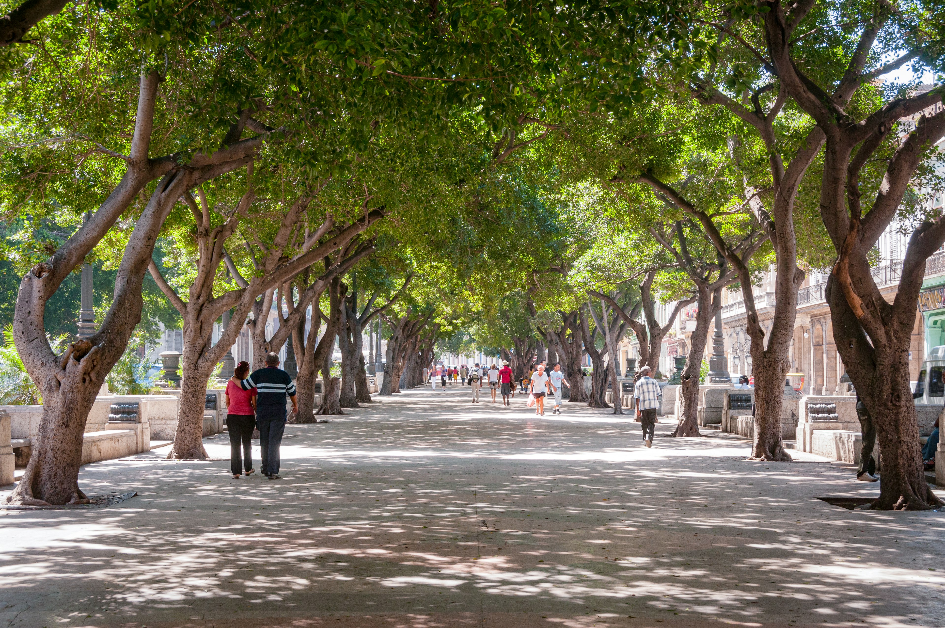 People walk down the Paseo de Martí in Havana, Cuba