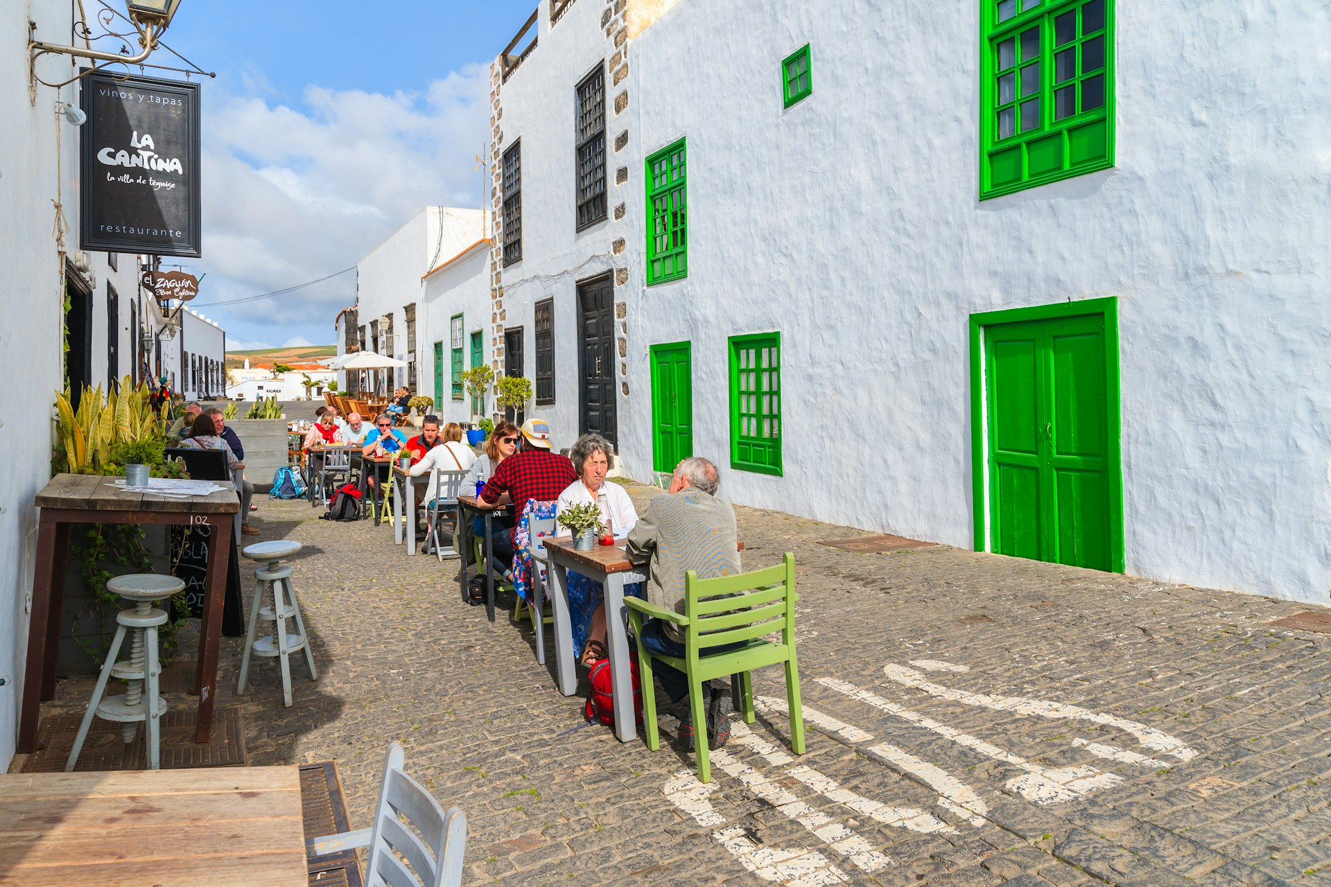 tourists sitting in local restaurant in old town of Teguise. This town is former capital of Lanzarote island and is very popular attraction to see.