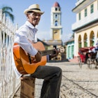 717168005
Musician in Trinidad, Cuba
guitarist, street musician, music, musician, Trinidad, playing, guitar, men, Central America, Caribbean, Cuba, musical instrument, stringed instrument, people, Adults, mature men, 55-59 years, square, skill, full length, Arts Culture and Entertainment, day, hat, Travel, casual clothing, shirt, outdoor, Native, sitting, authentic, Travel destination, Old Town, clear sky, one person, sky, sunlight, stool, Incidental People, confidence, relaxed, smiling, Joy, real people, content, building, tourism, carriage, making music, man, mature adults, 50 Plus Years, 50-60 years, city, sunshine, built structure, vehicle, horse cab, Photography, Color Image