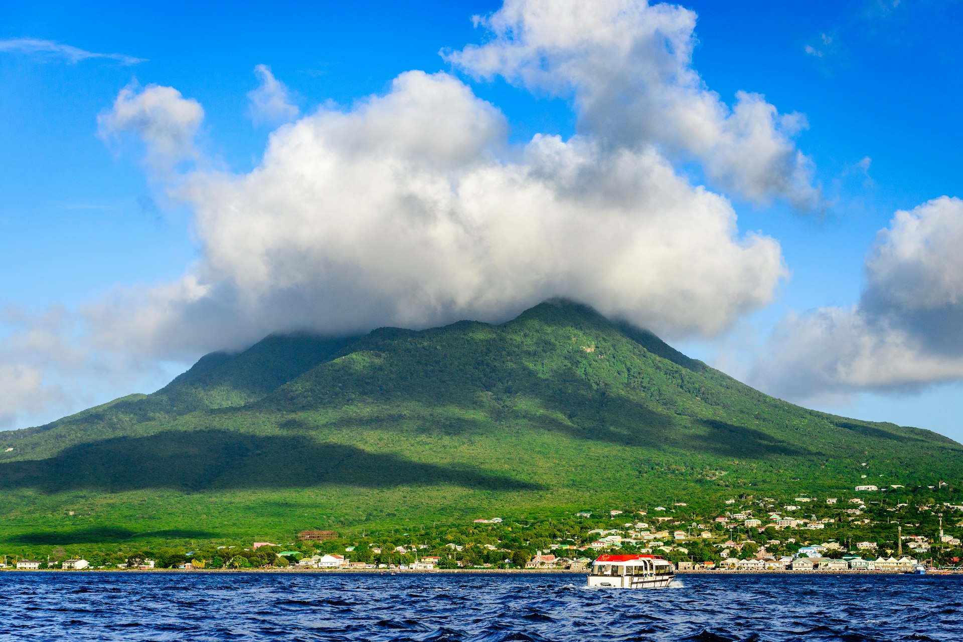 Nevis Peak topped with clouds, as viewed from the water