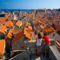 Couple looking over the red rooftops in Croatia