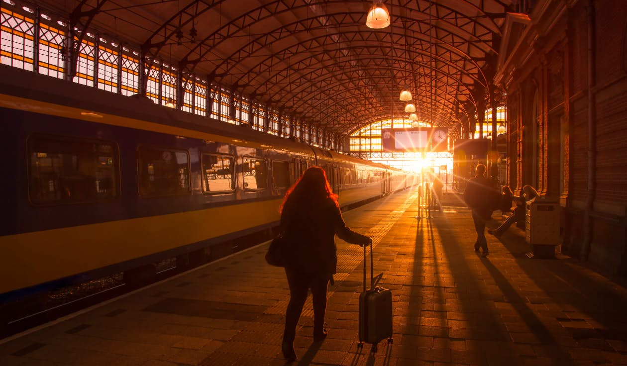 Boarding a train as the sun sets