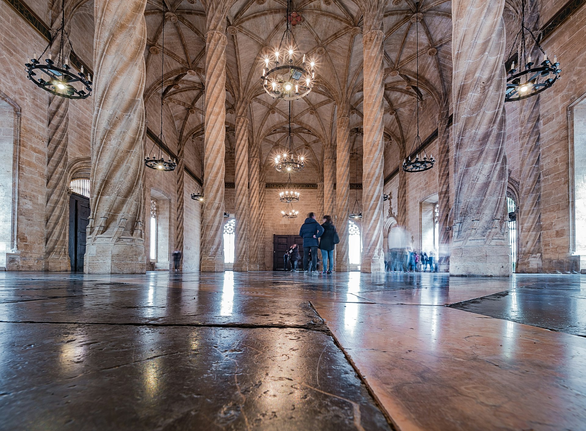 People explore an old building in the Valencia Gothic style