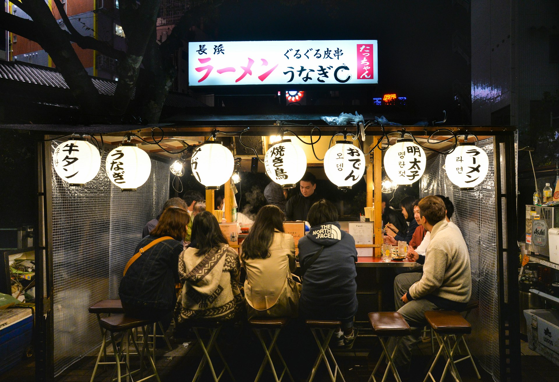 Diners at a counter at a yatai, Canal City, Fukuoka, Japan