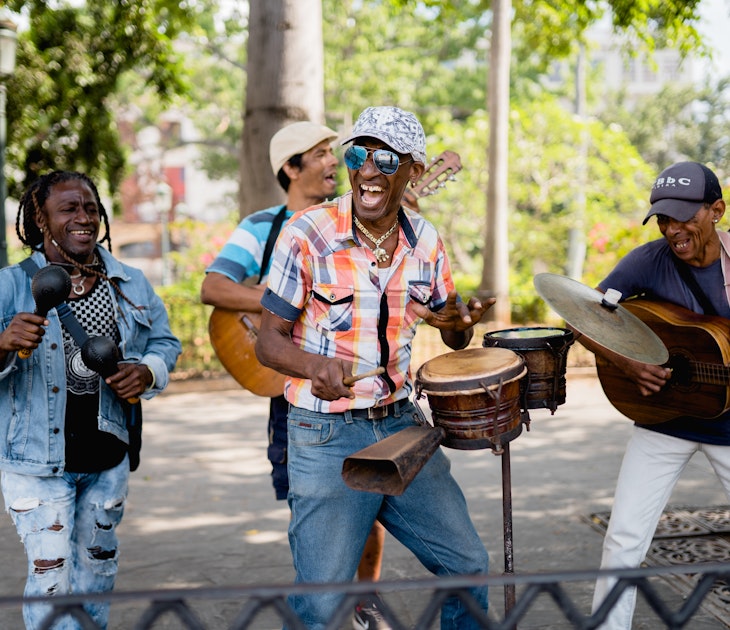 Happy cuban musicians playing live music on the street. They are smiling and playing different instruments as guitar and tambourine while they sing typical cuban songs. Photo from March, 2023.; Shutterstock ID 2298618495; full: 65050; gl: Online editorial; netsuite: Cuba best time to visit; your: Claire Naylor
2298618495