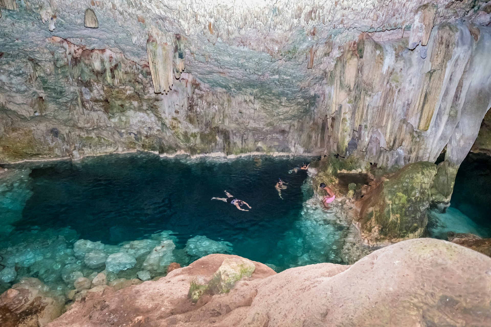 Swimmers in the underground Cueva de Saturno, near Varadero, Cuba