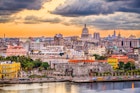 Downtown Havana skyline at dusk.
1020405811
architecture, building, buildings, business, capital, capitol, capitolio, caribbean, city, cityscape, cuba, cuban, dawn, district, dome, downtown, dusk, evening, famous, financial, government, habana, havana, historic, historical, hotels, landmark, landscape, location, malecon, monument, night, old, place, resorts, roof, rooftop, scene, scenery, scenic, skyline, spanish, sunset, tourism, tower, town, travel, twilight, urban, view