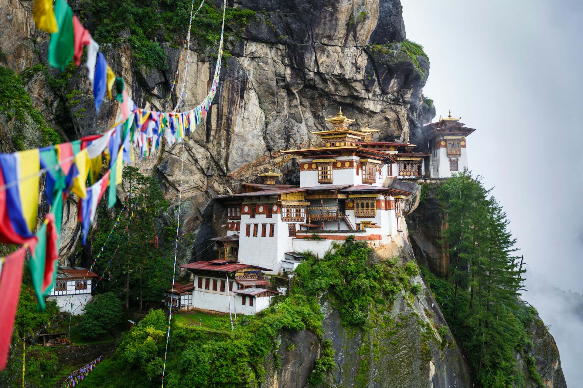 Taktsang (Tiger’s Nest) Monastery, near Paro, Bhutan, a white building clinging to the side of a sheer rock face