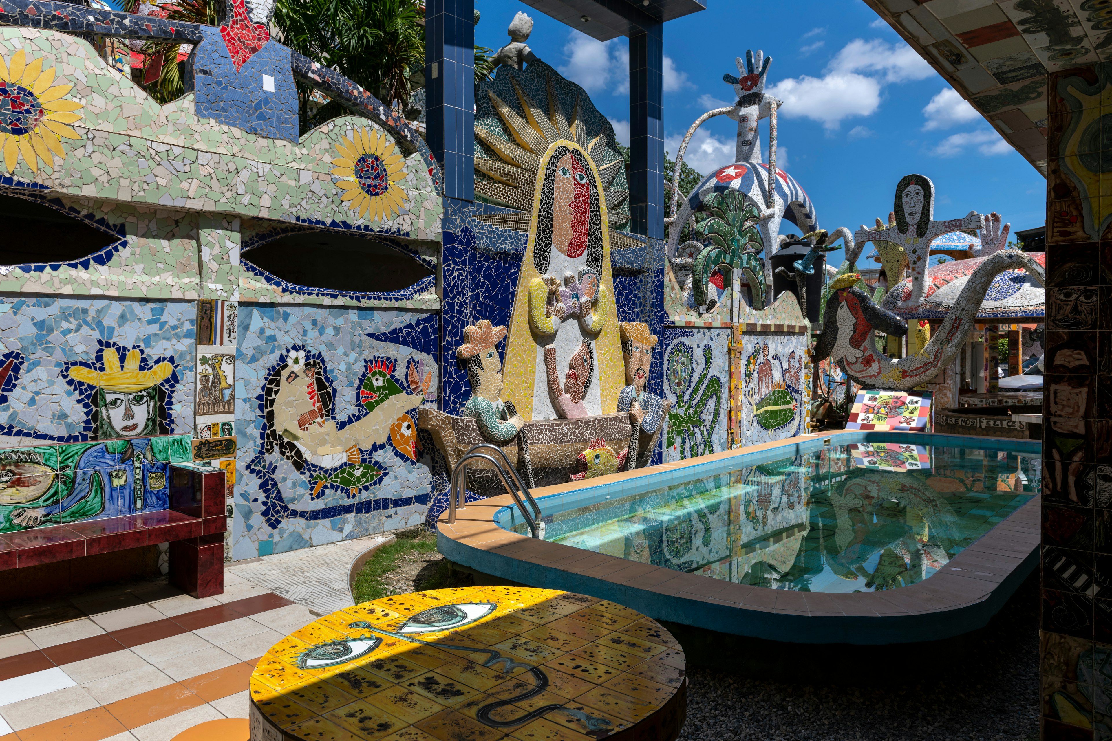 An outdoor pool area decorated with elaborate and colorful mosaic art in Jaimanitas, on the outskirts of Havana