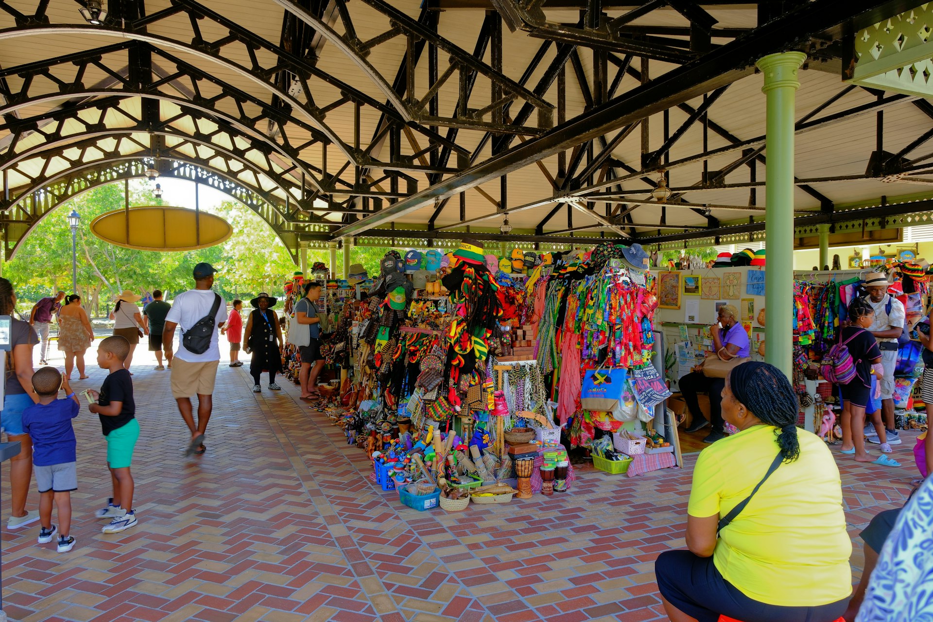 Tourists and vendors at an outdoor crafts market in Falmouth, Jamaica