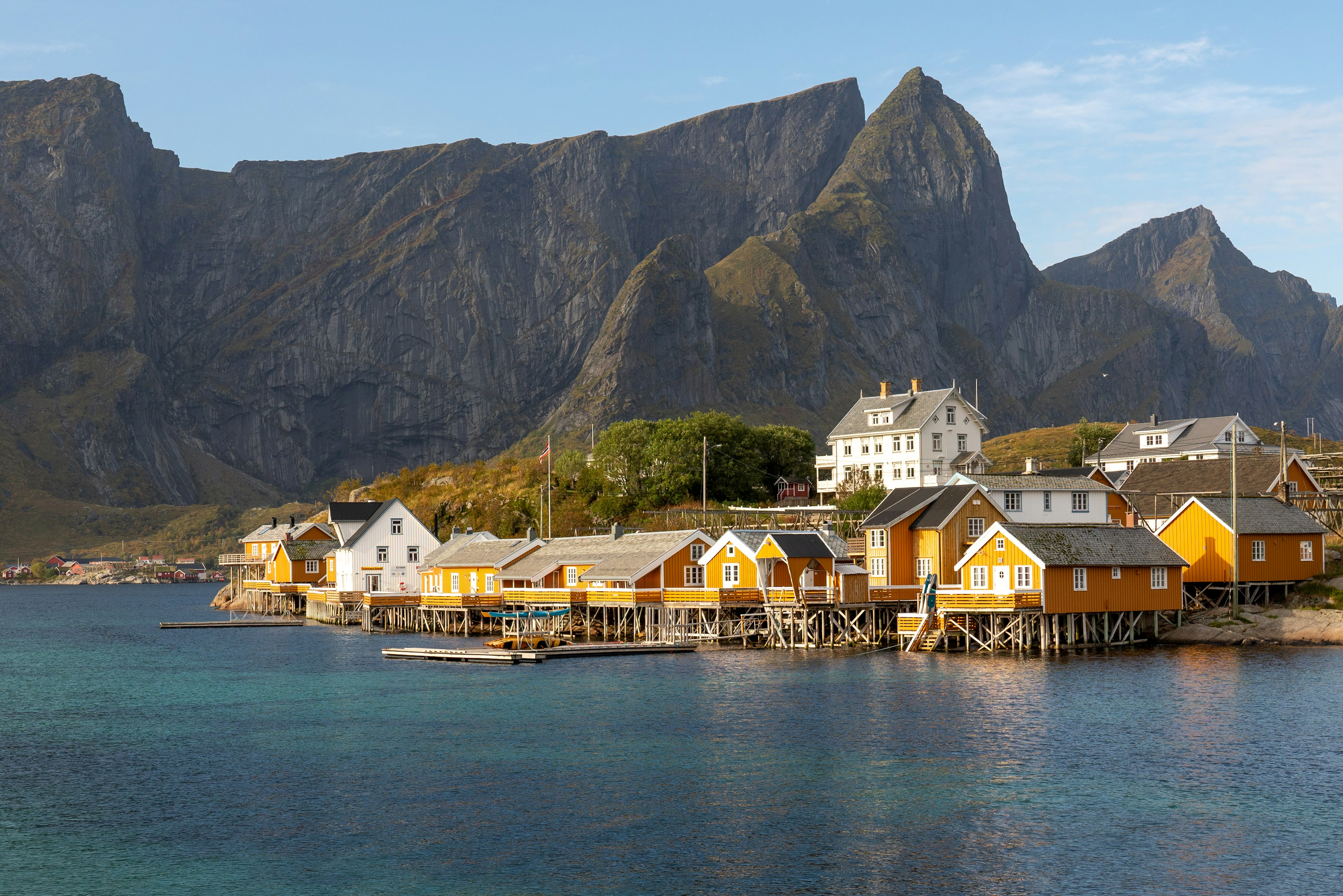 Brightly-coloured clapboard houses perched by the harbour in the Lofoten Islands