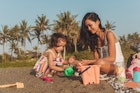 Mother and daughter relaxing on the beach together.
1055292950