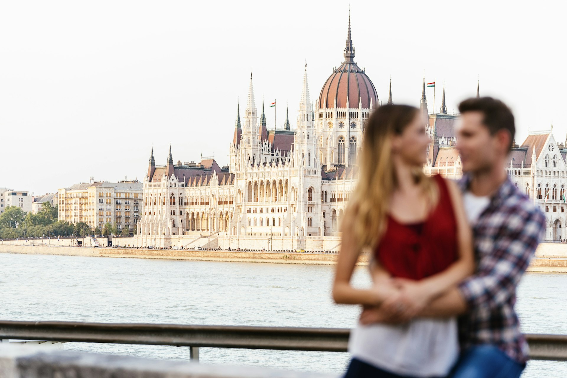 Young loving couple hugging in Budapest City. Focus in background