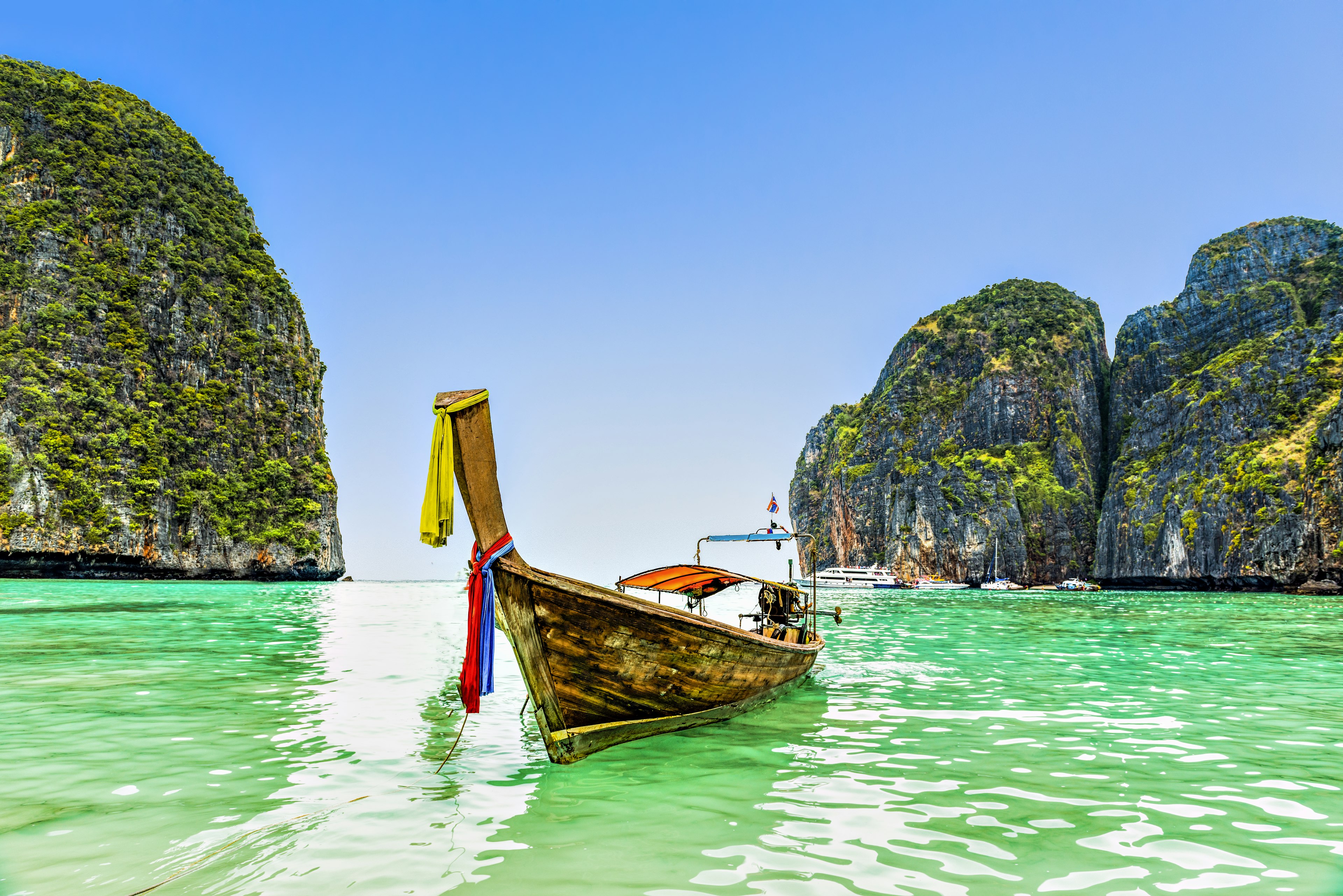 Thai boat in the blue waters of Ao Maya beach