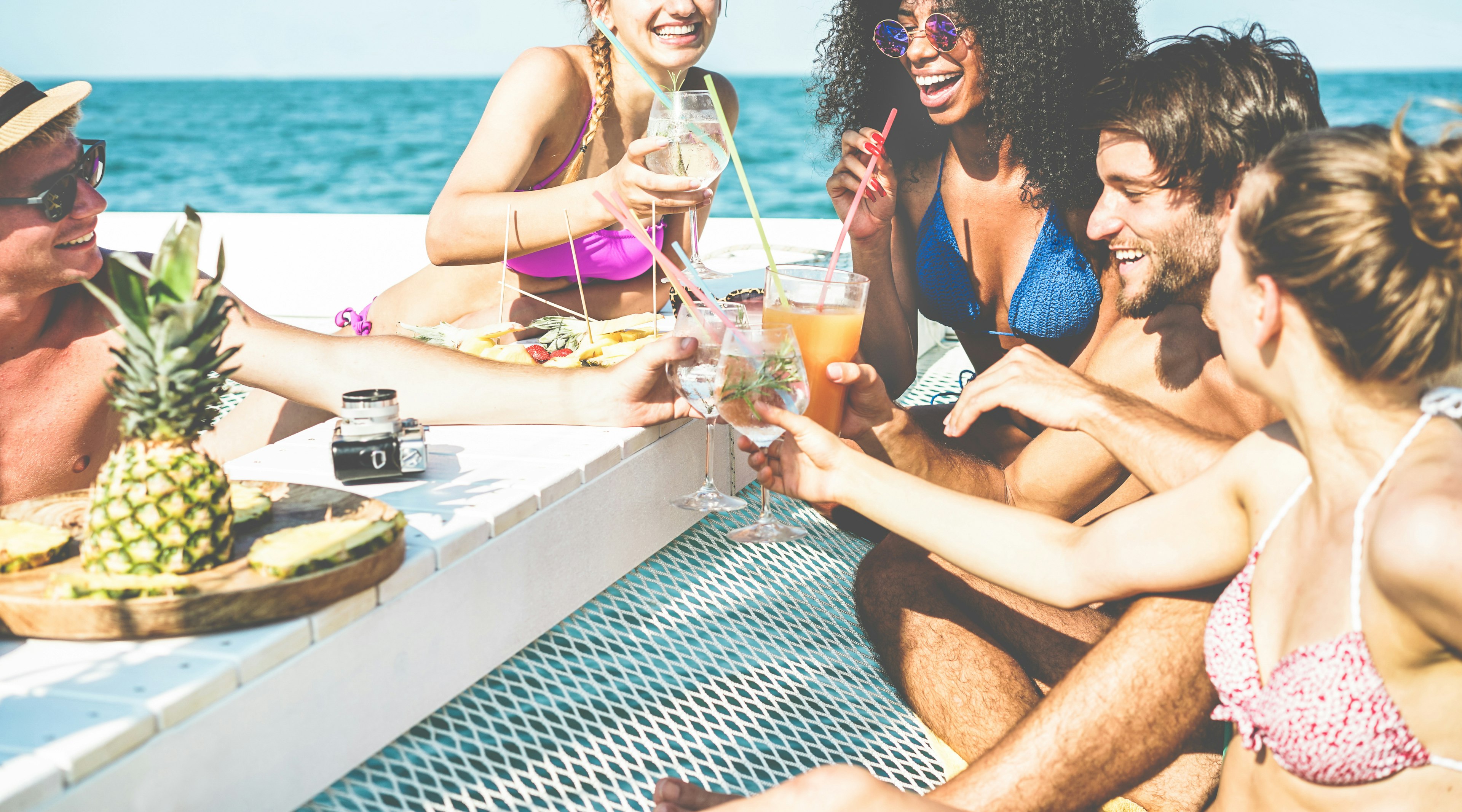 Group of friends drinking cocktails on a catamaran in Croatia