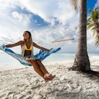 A woman smiling in a hammock in the Maldives