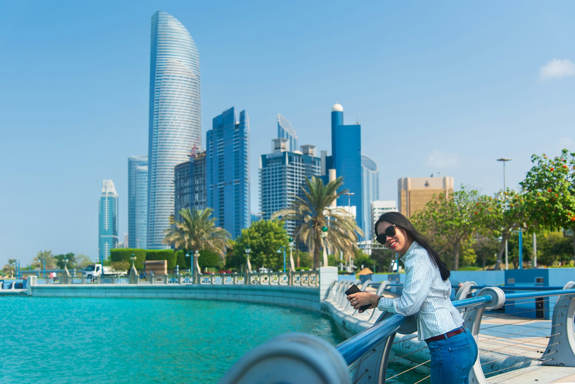 A woman looking out at the sea in Abu Dhabi's downtown Corniche area