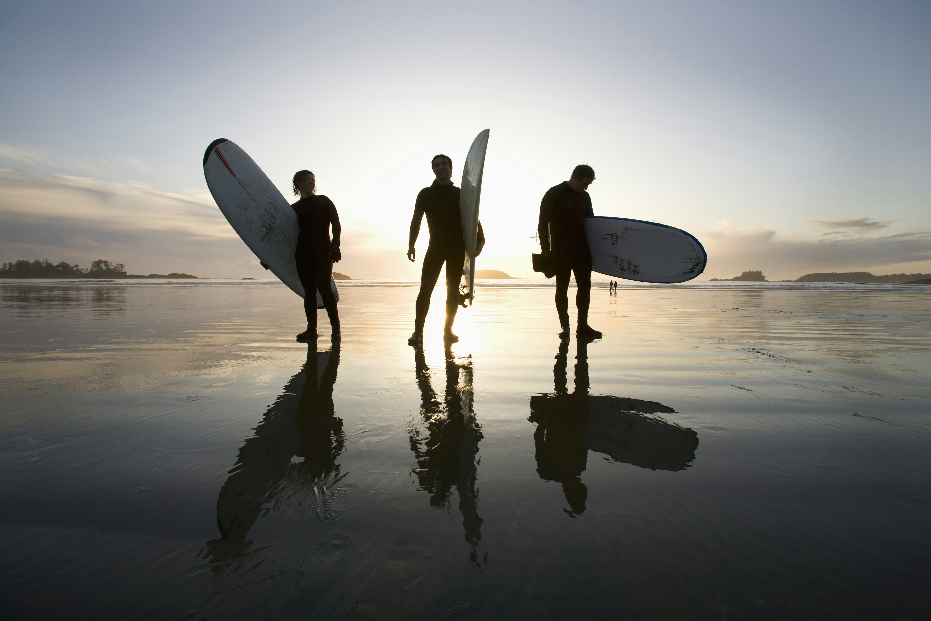 Surfers at sunset on Chesterman Beach, Tofino, Vancouver Island, British Columbia, Canada