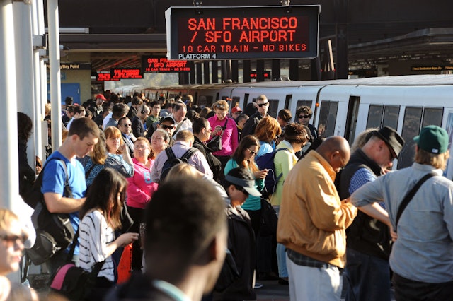 Crowds of commuters wait to board San Francisco bound trains at the MacArthur BART station in Oakland