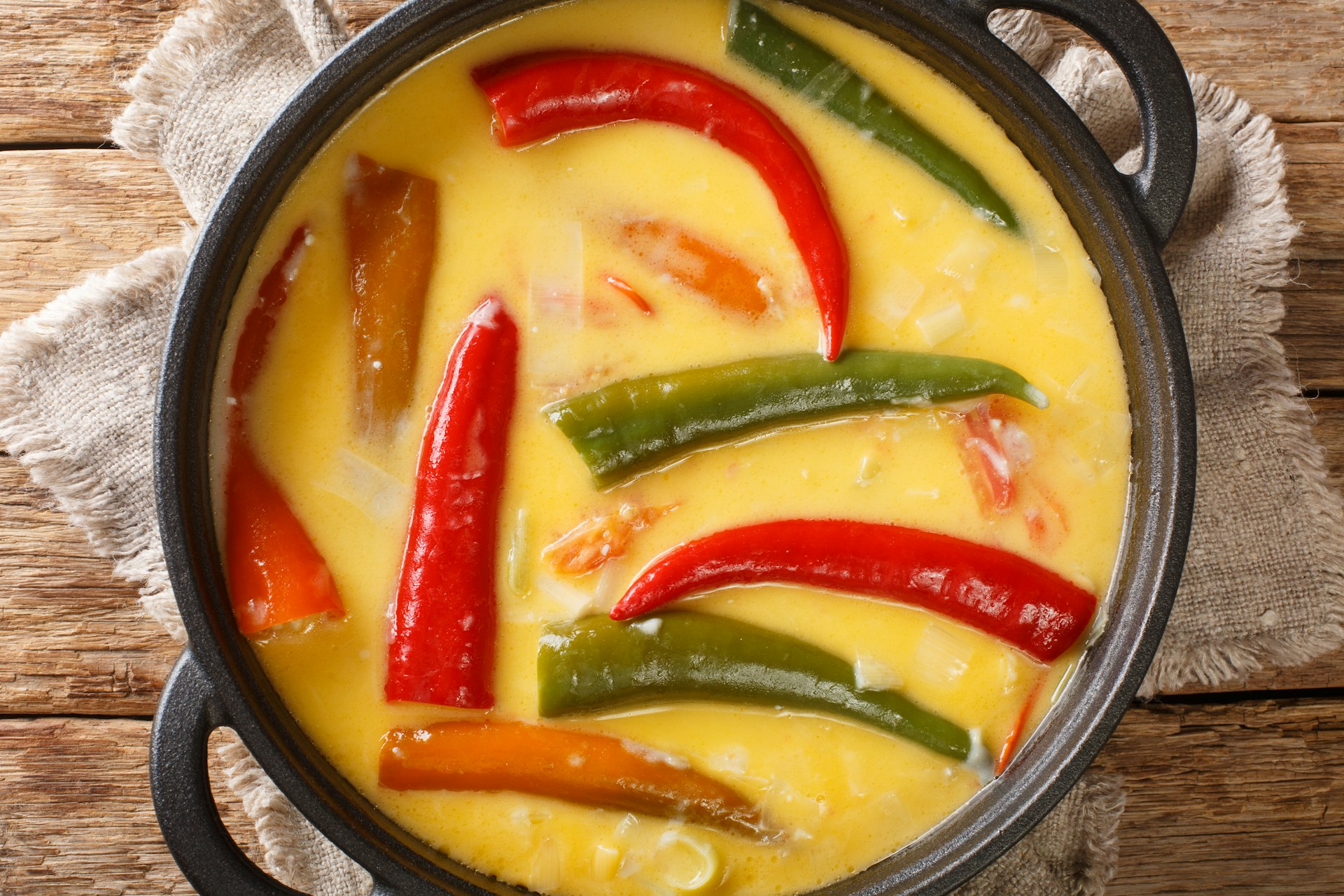 A top-down view of pan of chilies and cheese, or ema datse, the national dish of Bhutan