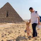 Father with daughter walking in front of the pyramid of Mikerin on the Giza plateau
1367244349