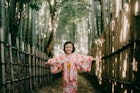 Happy young girl in kimono in bamboo forest, Japan
1369674947