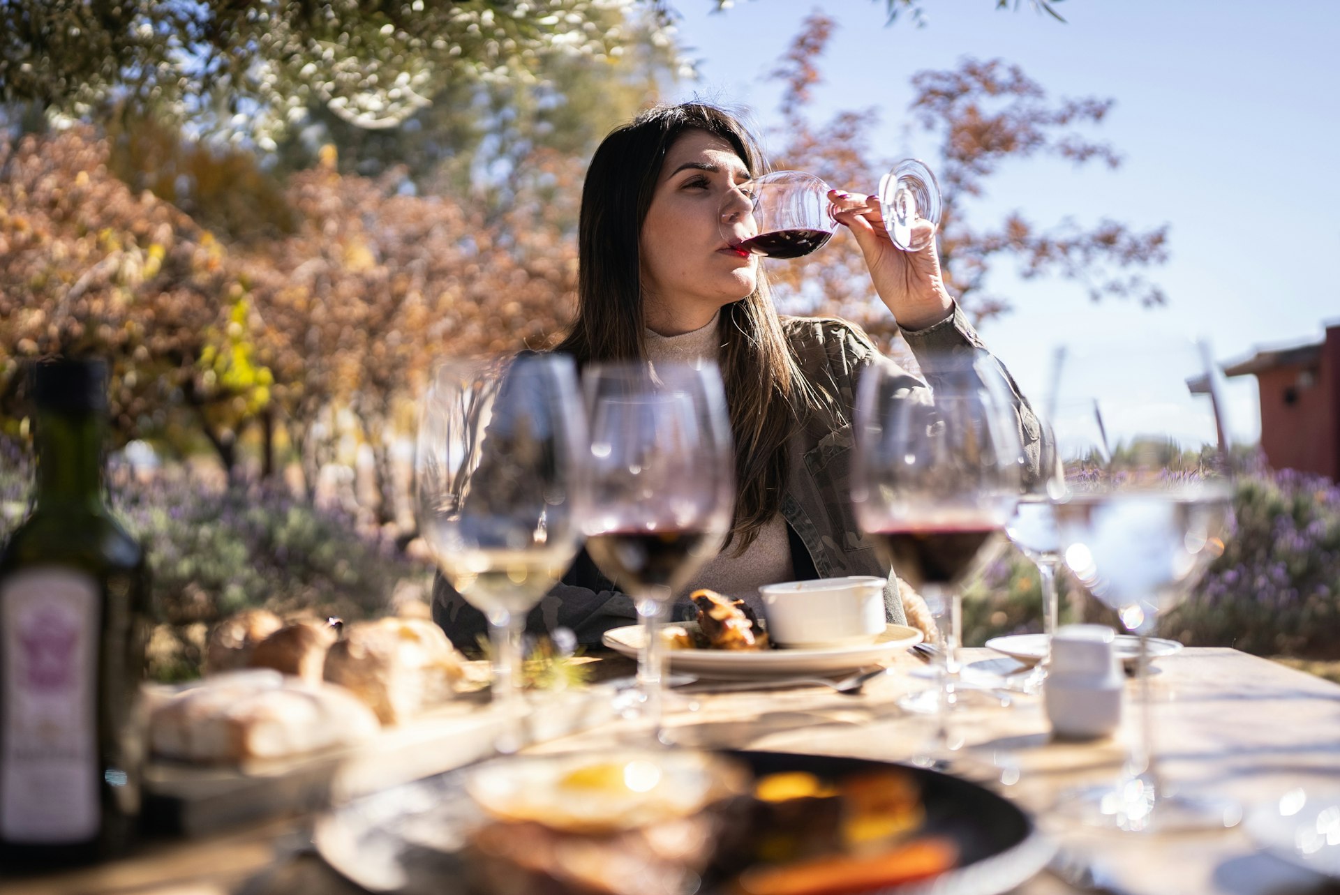 A woman takes a sip of red wine on a wine-tasting tour in Argentina