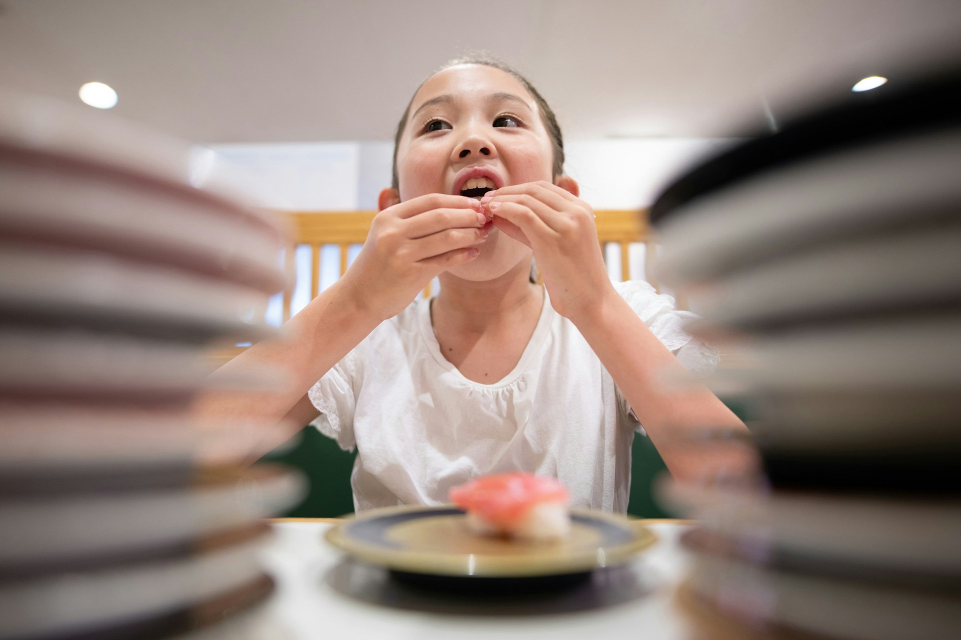 A child eats sushi that they have selected