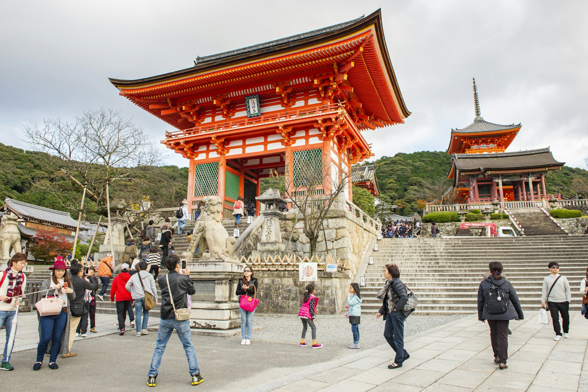 Autumn tourists sightseeing and taking photos of Kiyomizu-dera in Kyoto, Japan