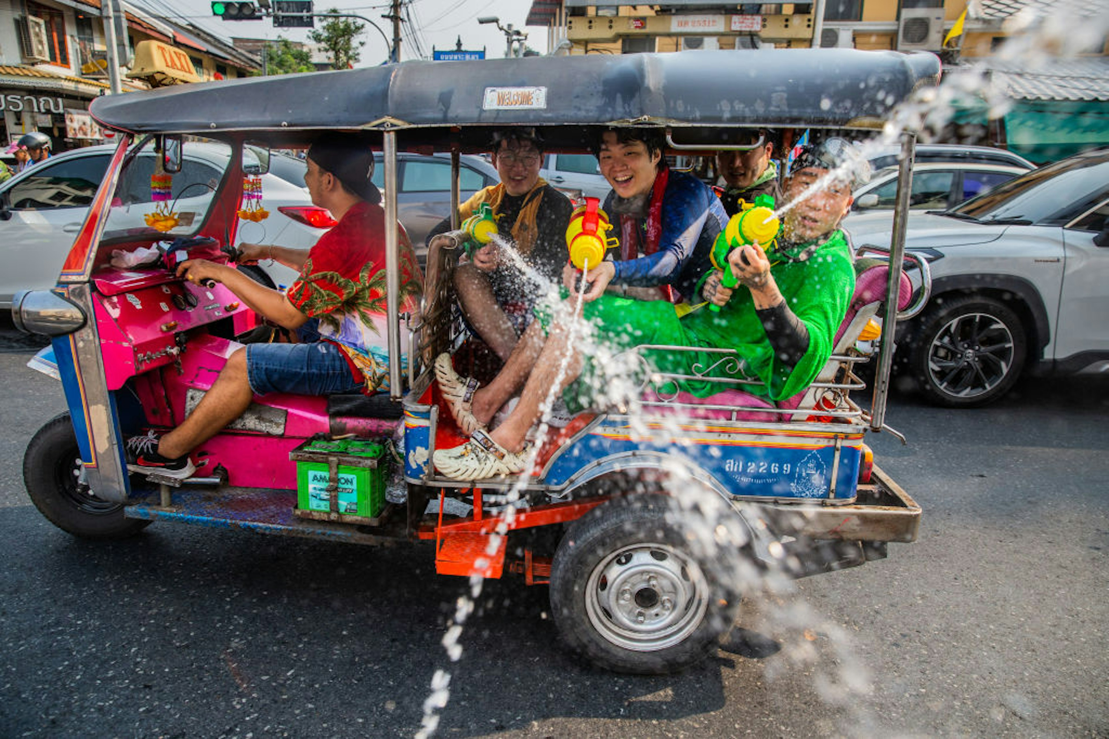 Tourists spray water guns out of a tuk tuk on Khaosan Road during the Songkran festival in Bangkok, Thailand.