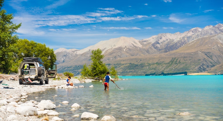 Joyful kids splash in Lake Pukaki's turquoise waters, surrounded by Southern Apls of South Island, New Zealand.
1489946951