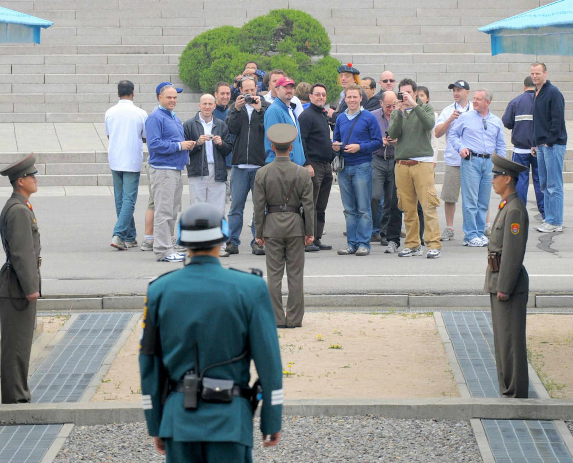 Foreign tourists on a tour of North Korea take pictures of South Korea on April 30, 2008 as they stand on the North Korean side of the border village of Panmunjom in the demilitarized zone that has separated the two Koreas since the Korean War