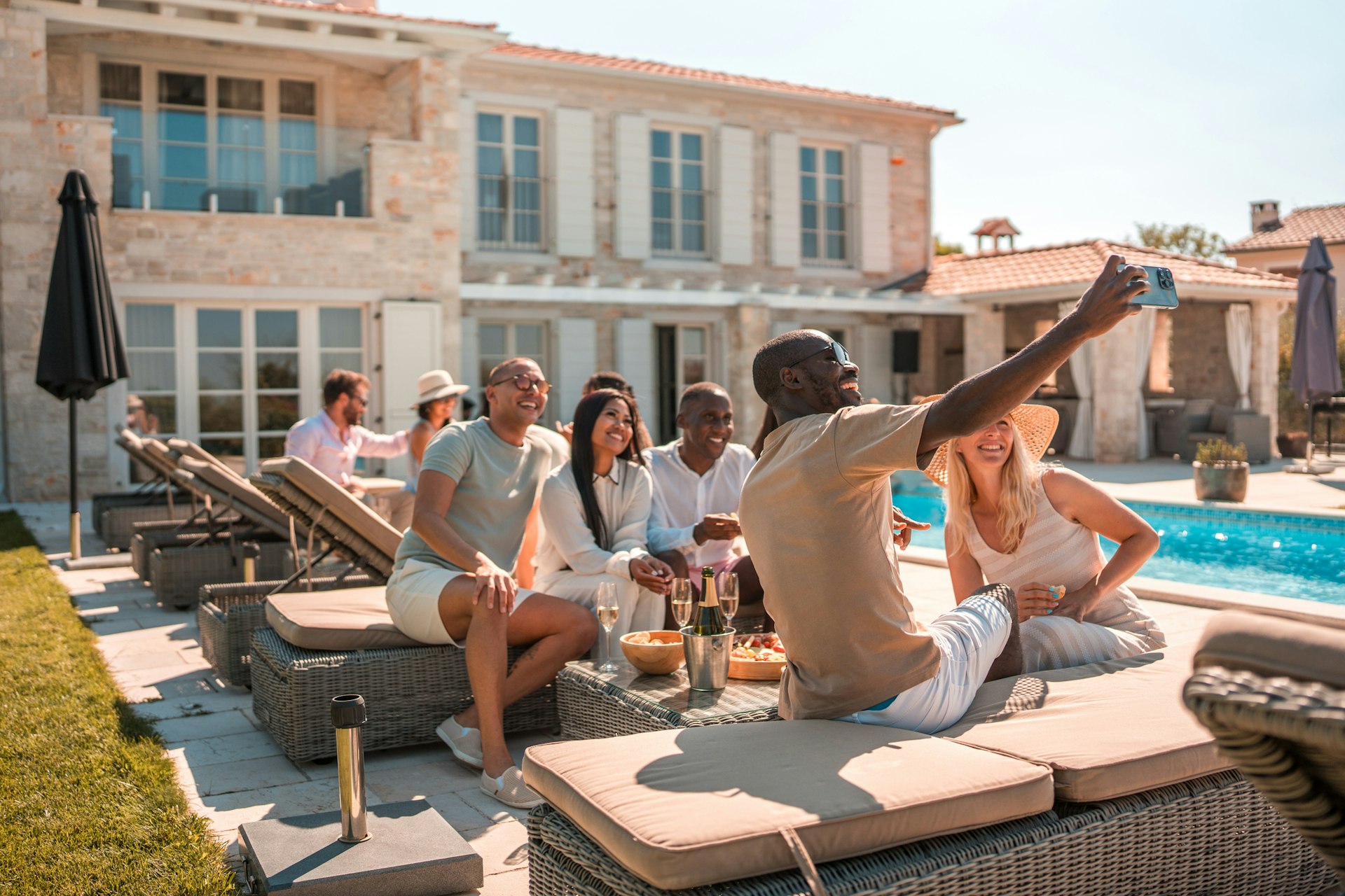 A group of friends taking a photo next to a villa and pool in Croatia