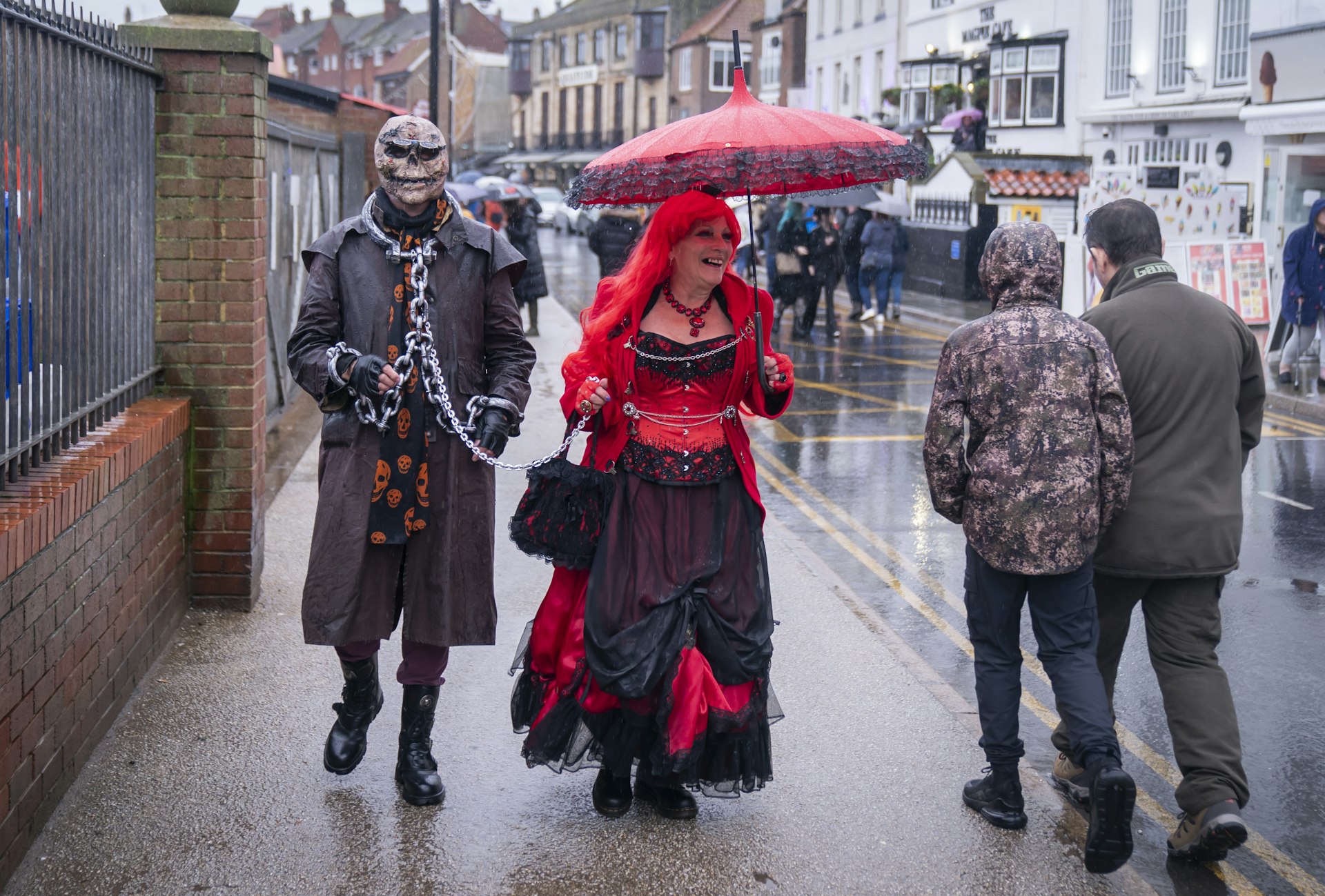People braving the rain as they attend the Whitby Goth Weekend in Whitby, Yorkshire, England, United Kingdom