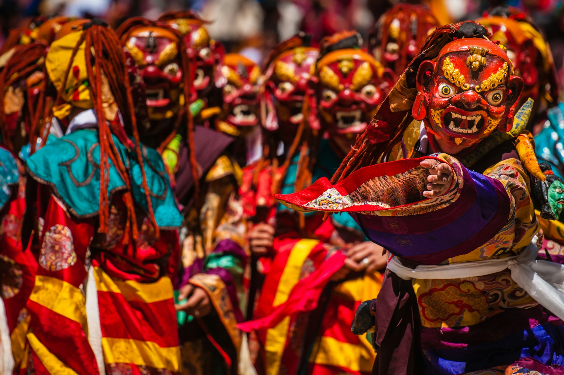 Masked performers participate in the tsholing dance at Paro Dzong, Bhutan