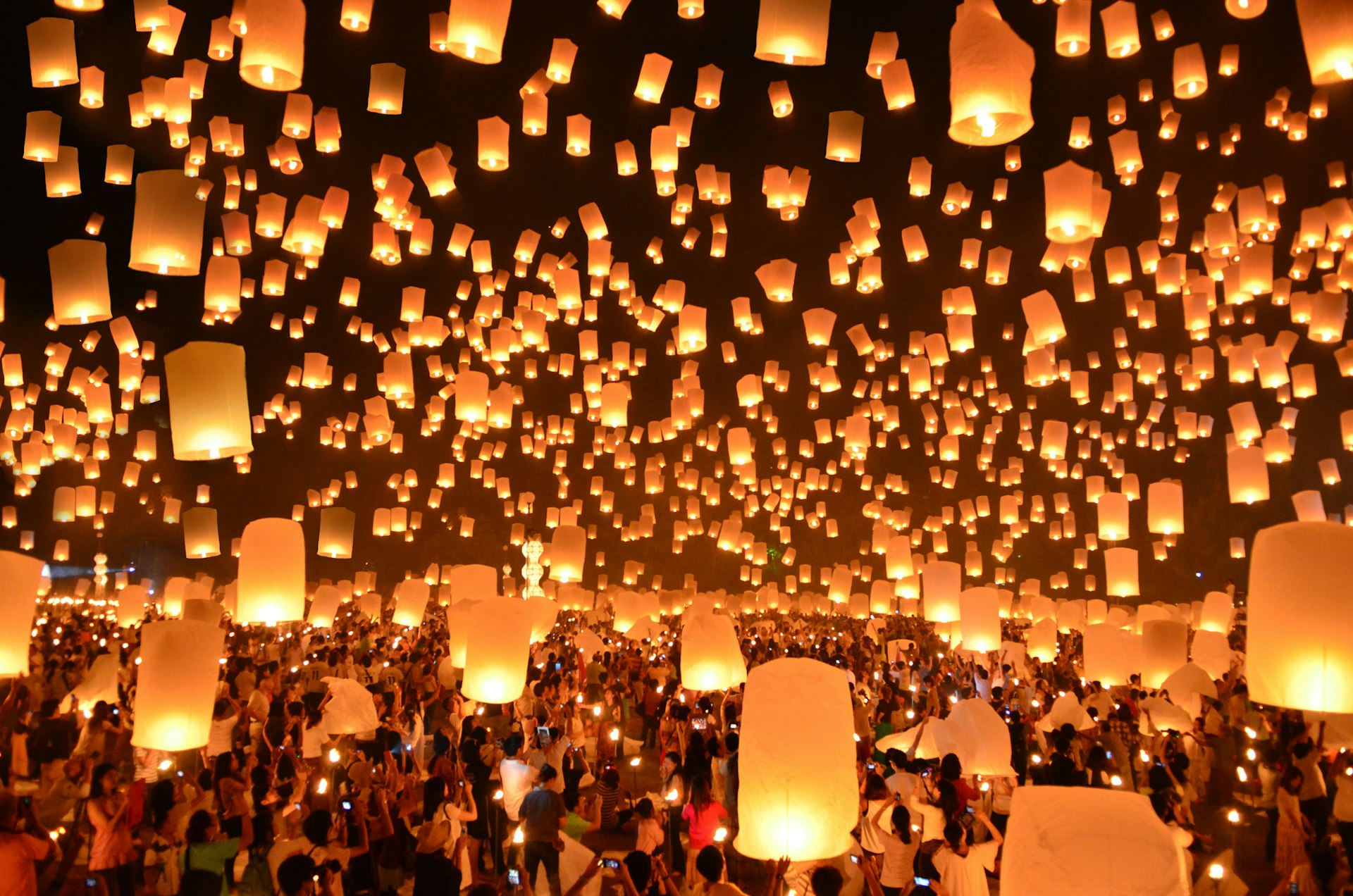 Scores of lit lanterns float in the dark skies of Thailand as part of the Loi Krathong festival 