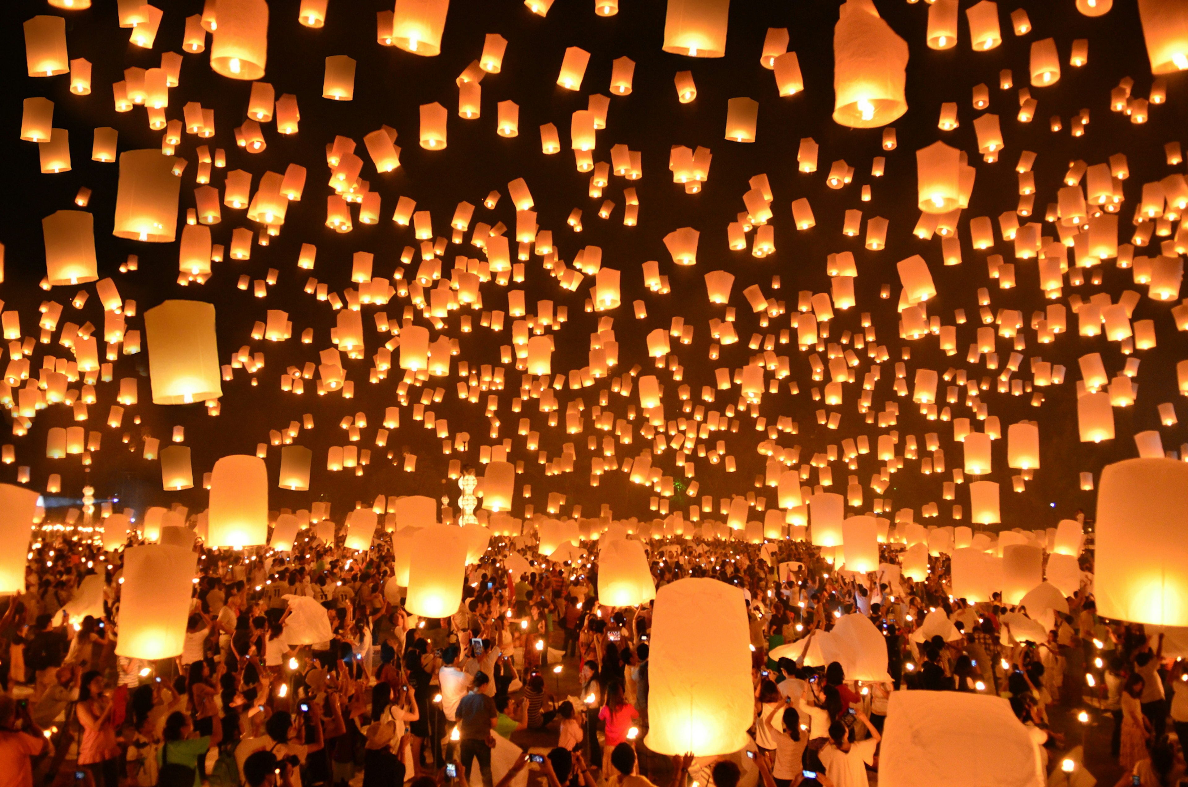 Scores of lit lanterns float in the dark skies of Thailand as part of the Loi Krathong festival