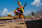 A person in traditional dress dancing at the Paro Tsechu festival, Bhutan