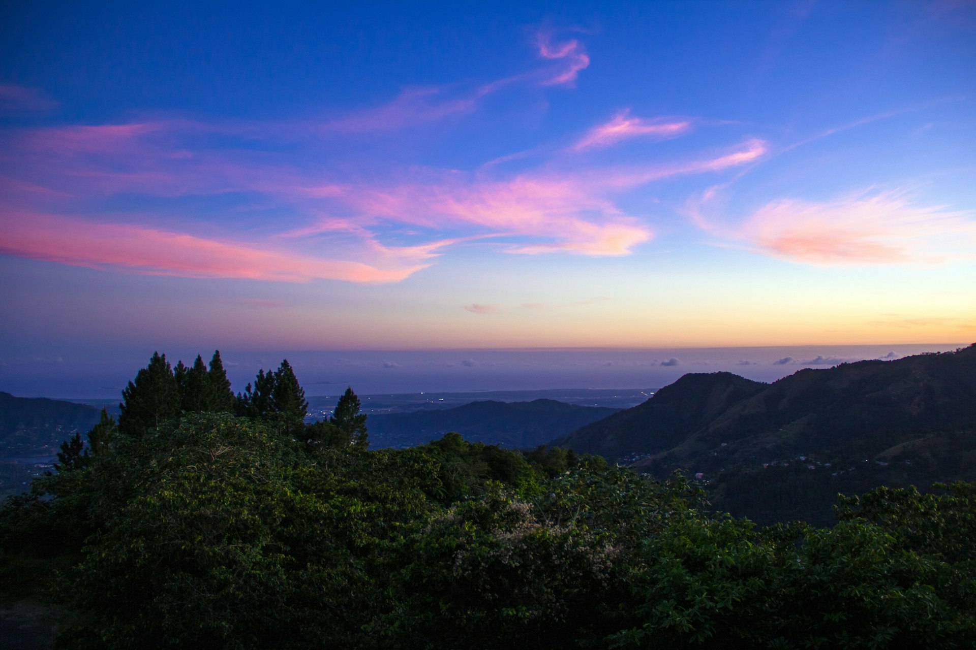 A violet-and-pink sunset view from Cordillera Central mountain range in Puerto Rico.
