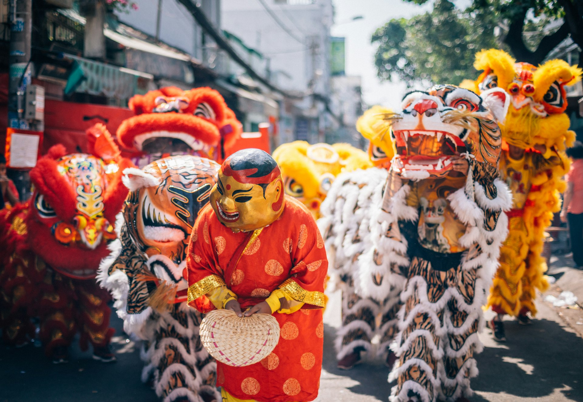 Dancing performers move through the streets of Ho Chi Minh City during the lunar new year