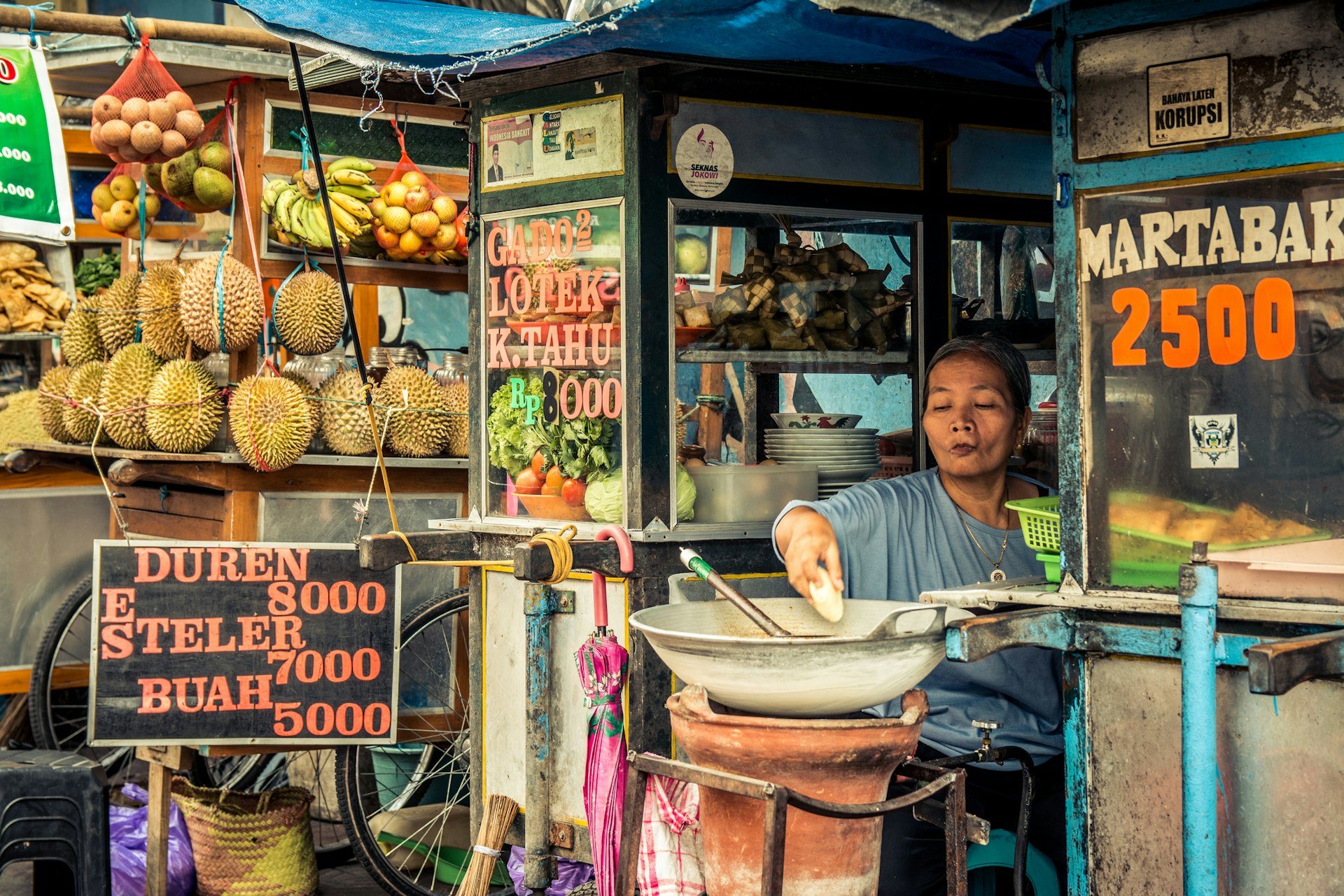 Local ambulant street vendor transporting her products on August 25, 2015 in Bali, Indonesia. Local vendors make an honest living selling snacks