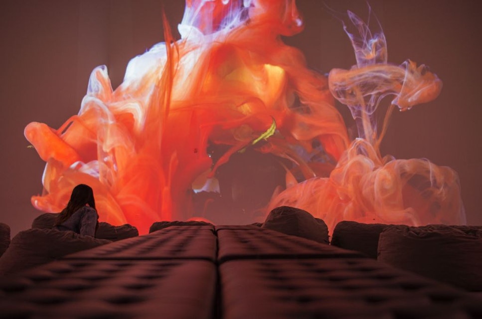 A visitor watches the Kingdom of Colors exhibition, an immersive visual experience from French filmmaker Thomas Blanchard and artist Oilhack, at the ARTECHOUSE gallery in Washington, DC on November 8, 2017..It all began as an accident. After hurting his wrist, artist Oilhack started mixing paints, oil and soap in a bowl, experiments that eventually morphed into brightly colored moving seascapes in a collaboration with fellow Frenchman Thomas Blanchard that Apple used to promote its iPhone X. In their US debut, the pair who form the WeAreColorful collaborative are bringing an immersive experience featuring 270-degree projections of their liquid mixtures that fill the main gallery space at Artechouse, a venue marrying art, science and technology in Washington. . / AFP PHOTO / Andrew CABALLERO-REYNOLDS / RESTRICTED TO EDITORIAL USE - MANDATORY MENTION OF THE ARTIST UPON PUBLICATION - TO ILLUSTRATE THE EVENT AS SPECIFIED IN THE CAPTION        (Photo credit should read ANDREW CABALLERO-REYNOLDS/AFP via Getty Images)
872268936
arts, Horizontal