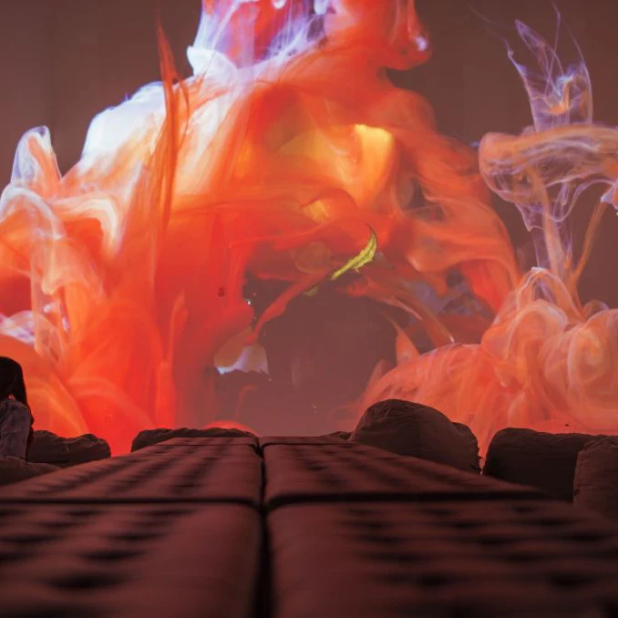 A visitor watches the Kingdom of Colors exhibition, an immersive visual experience from French filmmaker Thomas Blanchard and artist Oilhack, at the ARTECHOUSE gallery in Washington, DC on November 8, 2017..It all began as an accident. After hurting his wrist, artist Oilhack started mixing paints, oil and soap in a bowl, experiments that eventually morphed into brightly colored moving seascapes in a collaboration with fellow Frenchman Thomas Blanchard that Apple used to promote its iPhone X. In their US debut, the pair who form the WeAreColorful collaborative are bringing an immersive experience featuring 270-degree projections of their liquid mixtures that fill the main gallery space at Artechouse, a venue marrying art, science and technology in Washington. . / AFP PHOTO / Andrew CABALLERO-REYNOLDS / RESTRICTED TO EDITORIAL USE - MANDATORY MENTION OF THE ARTIST UPON PUBLICATION - TO ILLUSTRATE THE EVENT AS SPECIFIED IN THE CAPTION (Photo credit should read ANDREW CABALLERO-REYNOLDS/AFP via Getty Images)
872268936
arts, Horizontal