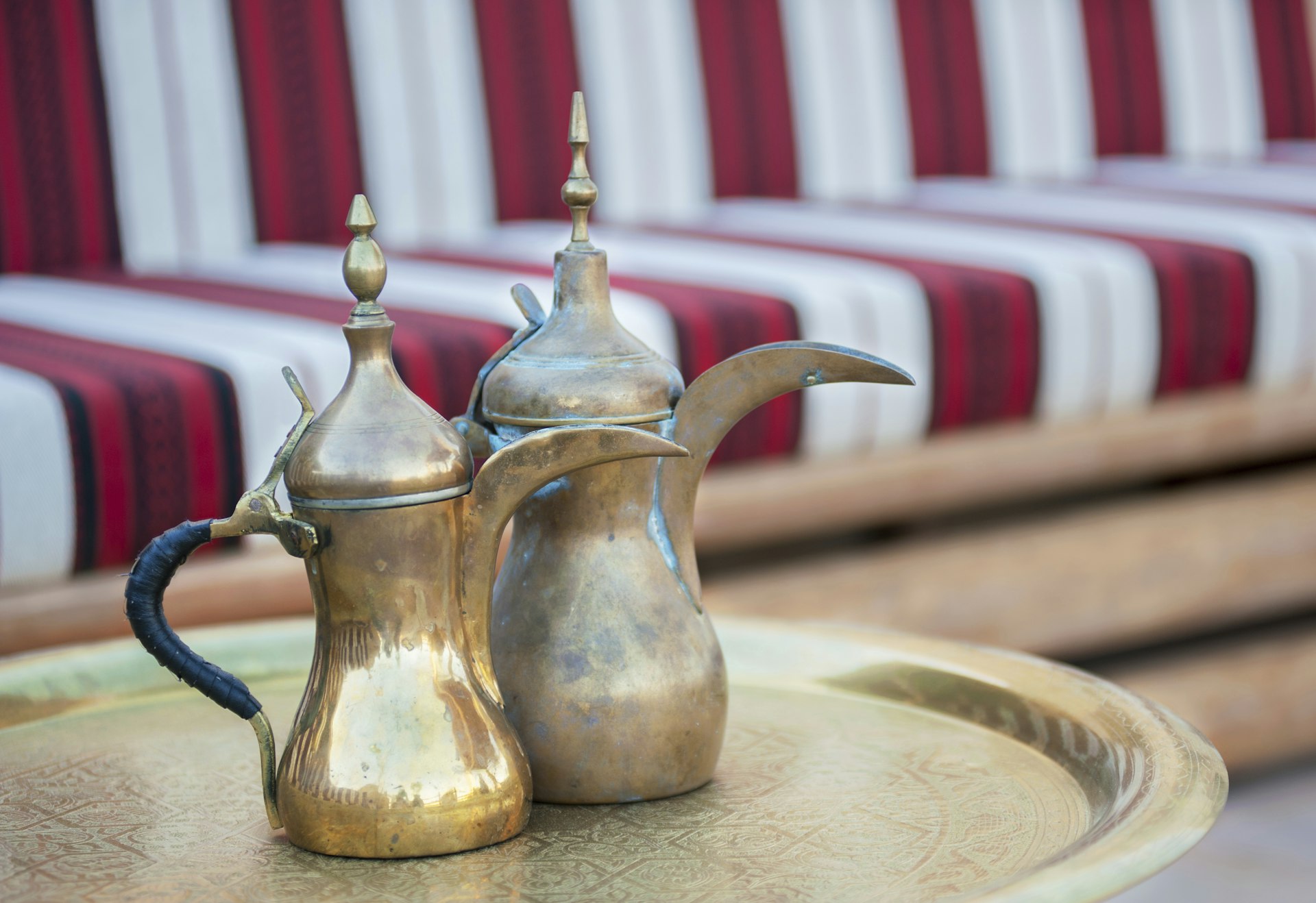 Old Arabic brass coffee pots on metal tray in Abu Dhabi