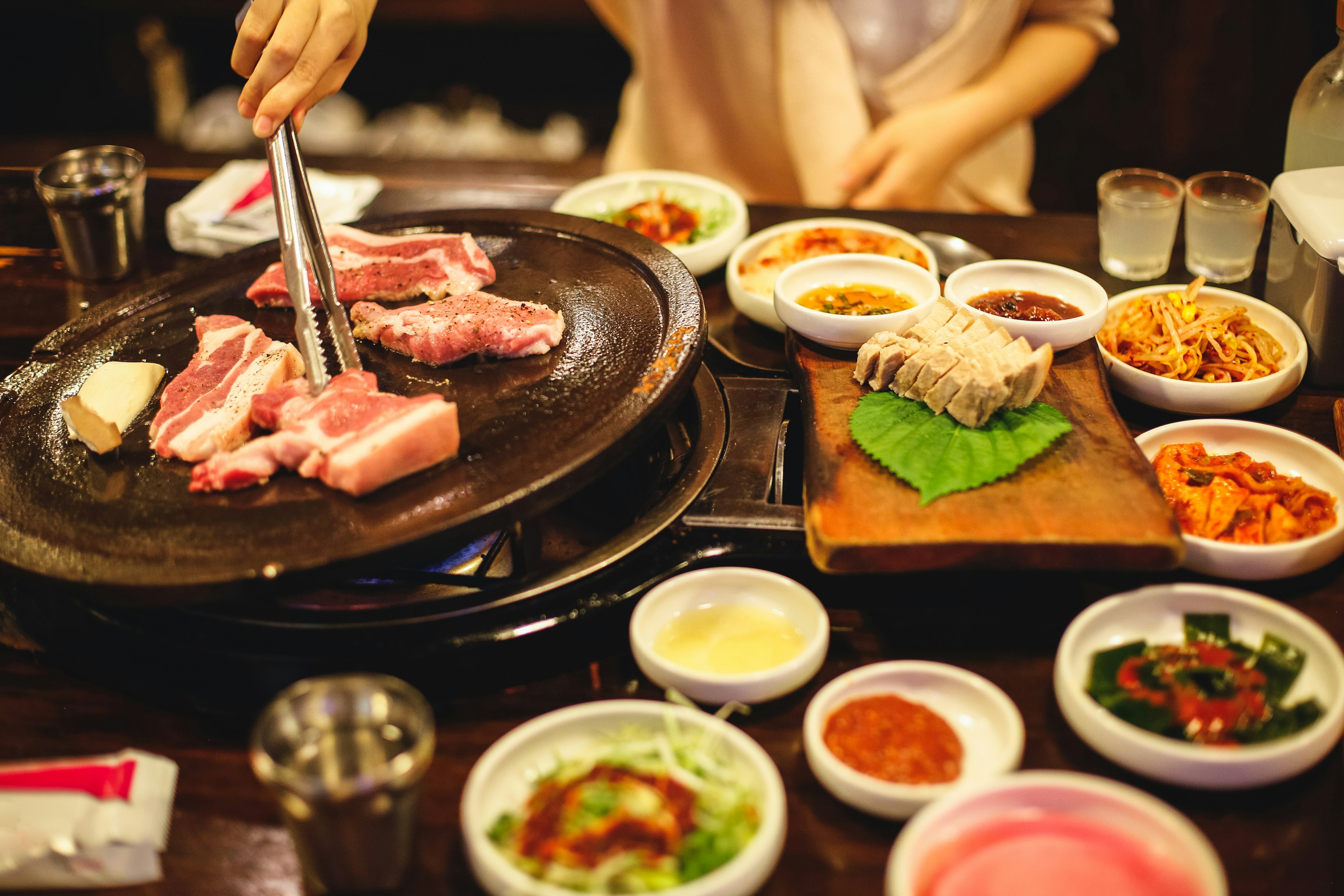 The famous Korean Barbecue with thick slabs of pork belly and a variety of side dishes, Jeju Island