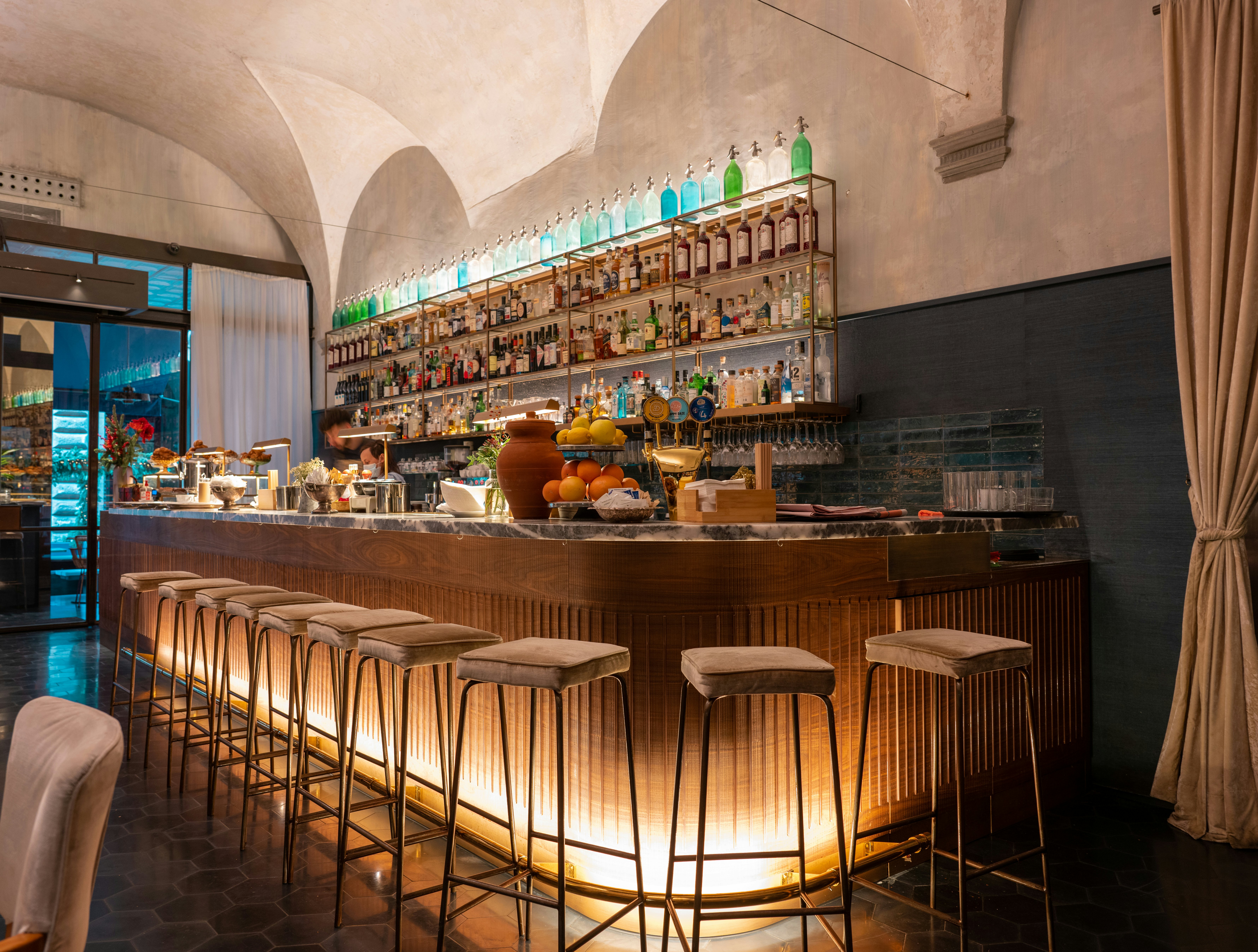 Stools lined up neatly at a restaurant bar