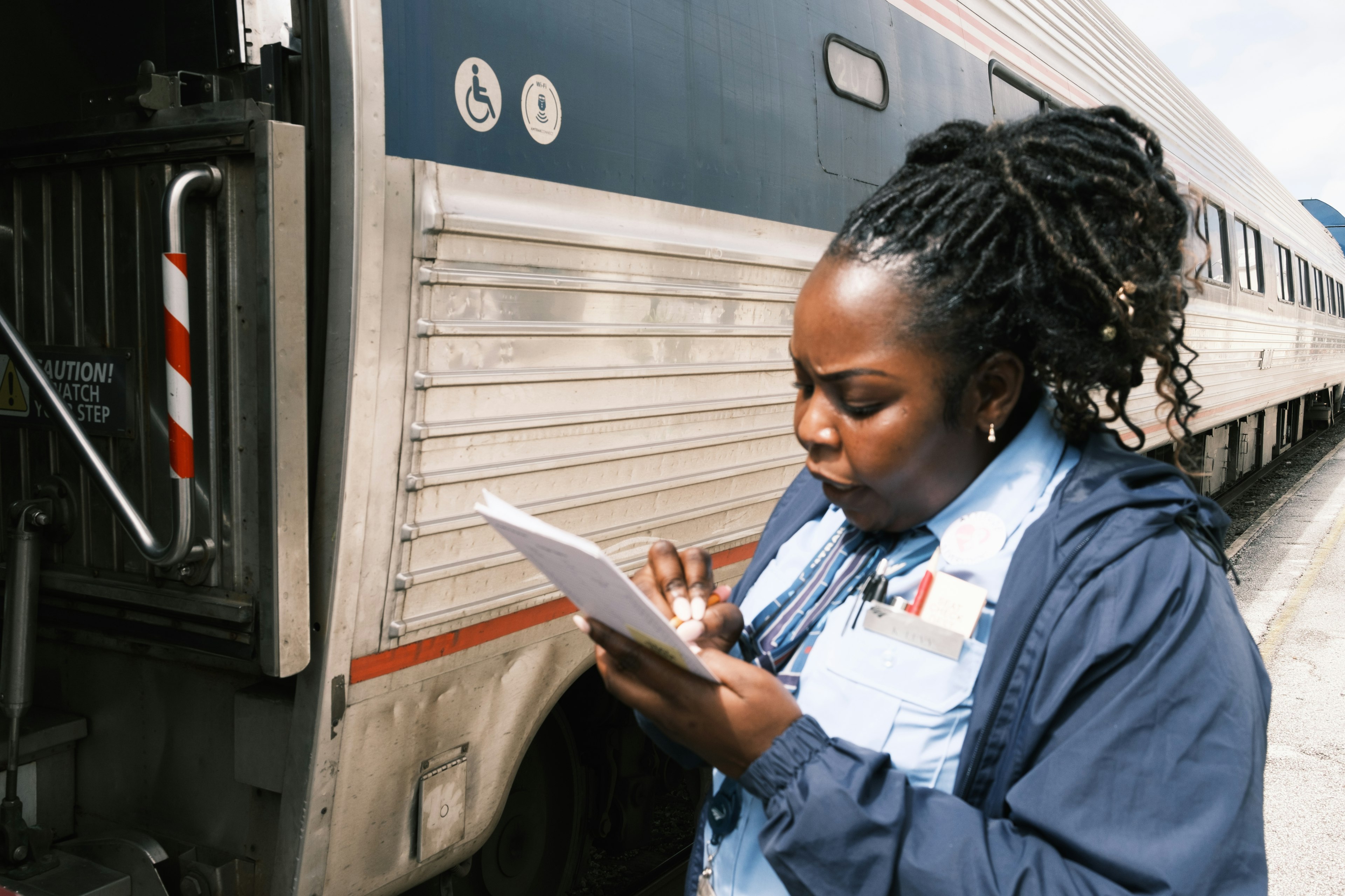 An attendant on the Silver Meteor ticks off passenger names before they board