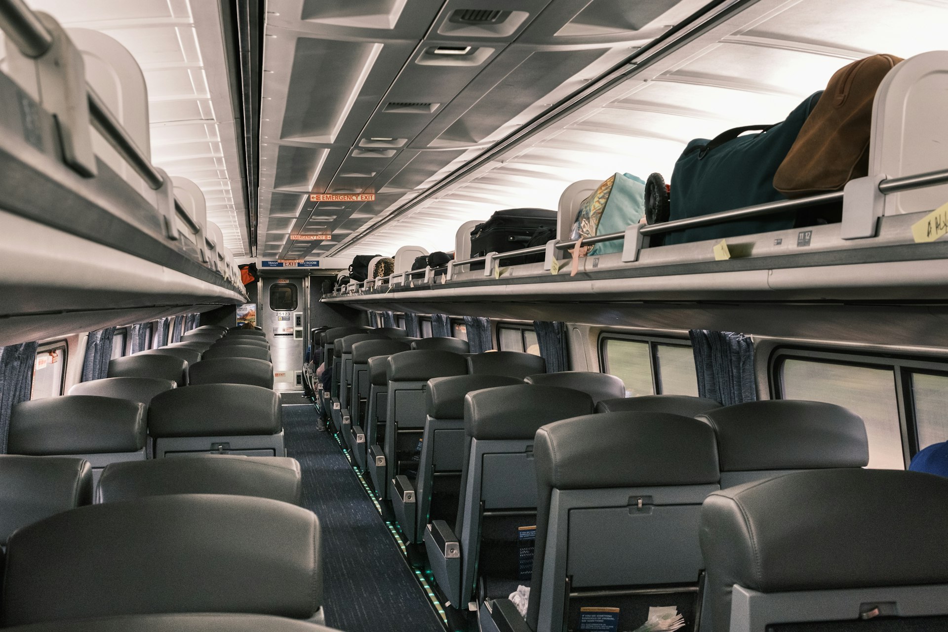 The interior of the Silver Meteor showing the blue seats and luggage compartments above