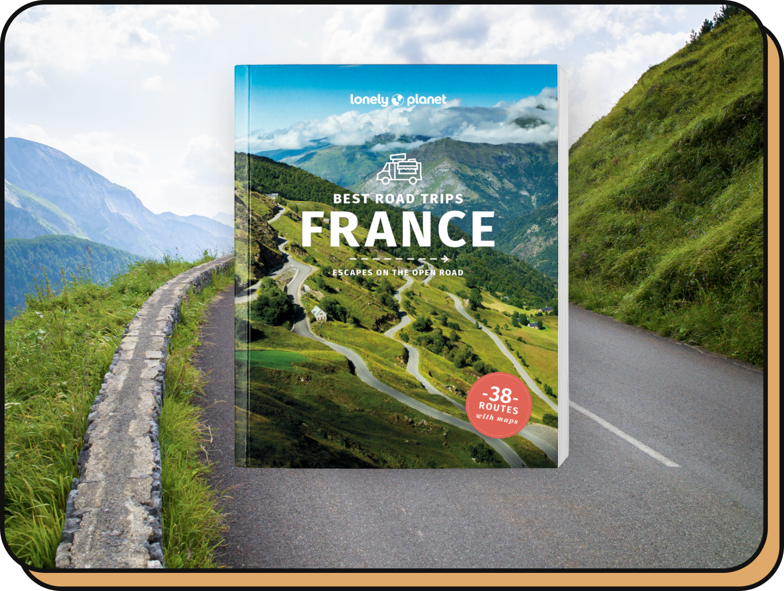 Best Road Trips France book alongside a mountain landscape